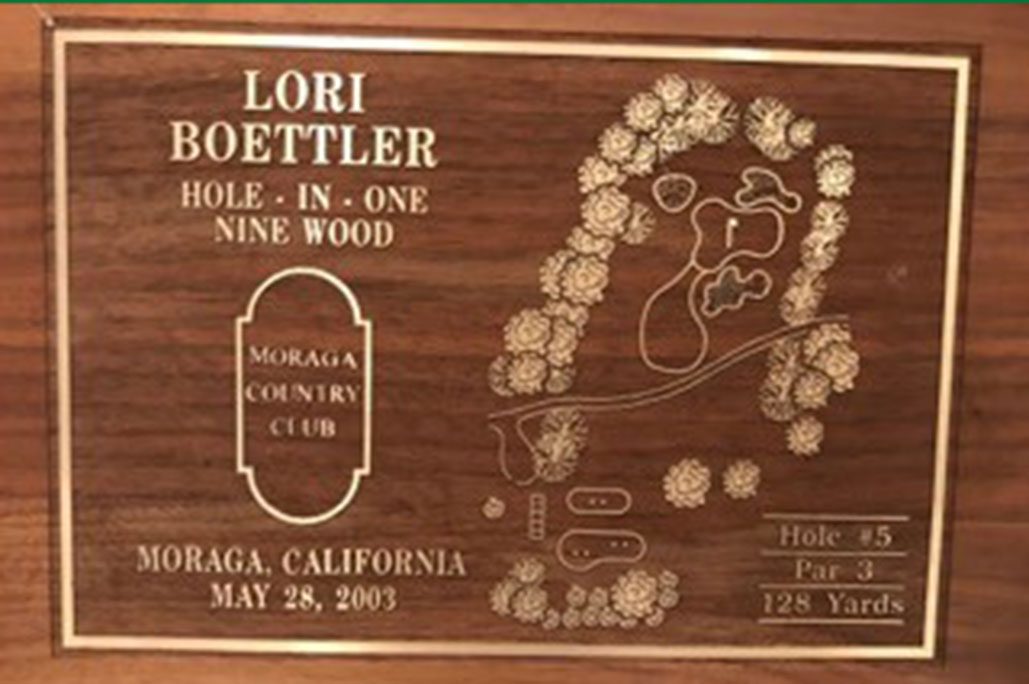 A wooden sign commemorating Lori Boettler's hole-in-one at Moranga Country Club's Hole 5 in 2003.