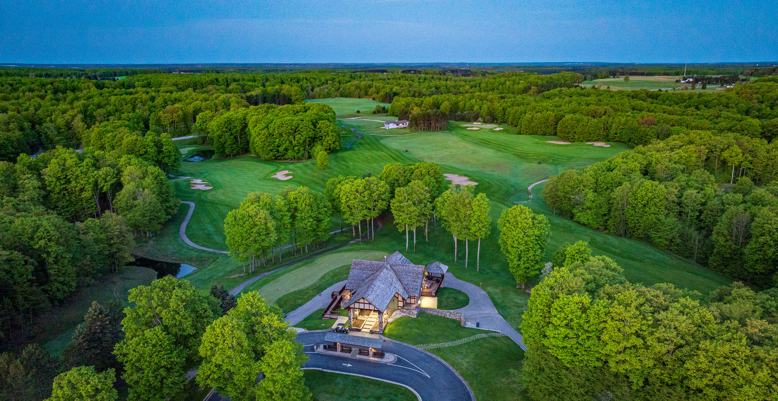 Golfers enjoying Treetops Resort at golden hour